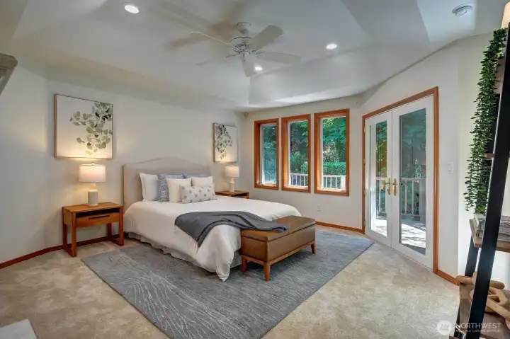 The primary suite with new carpet offers a peaceful retreat with private deck access.