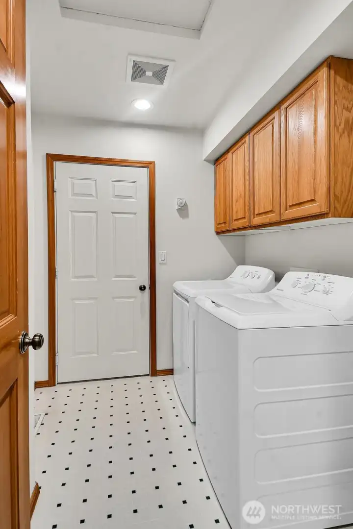 Large laundry room with abundant storage. All appliances stay!