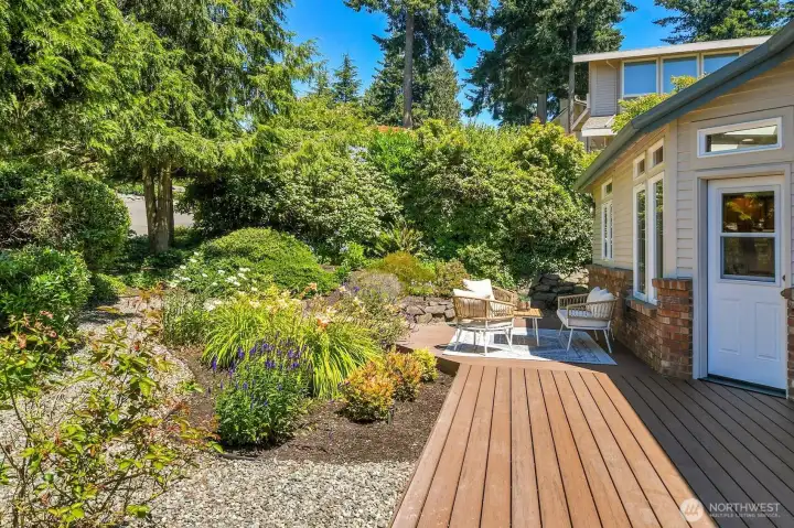 Lush landscaping surrounds the composite deck and has access right into the kitchen for ease of entertaining.