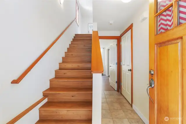 Front entrance, stairs leading up to main level, lower level bedroom to the right