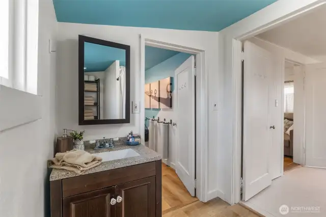 3/4 bathroom leading to bedroom and utility entry hall.