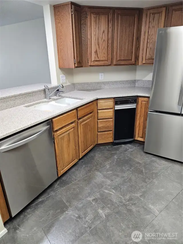 KITCHEN WITH BREAKFAST BAR. OPENS TO DINING ROOM AND LIVING ROOM