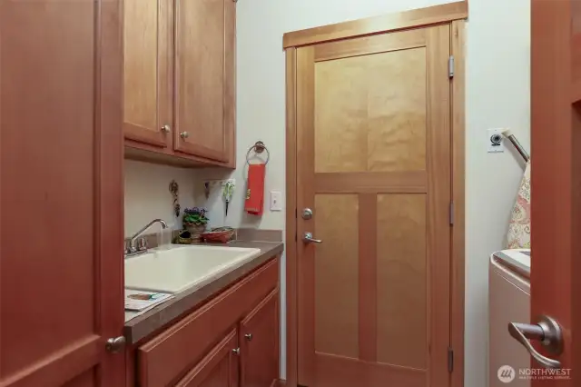 Utility room with sink and door to garage