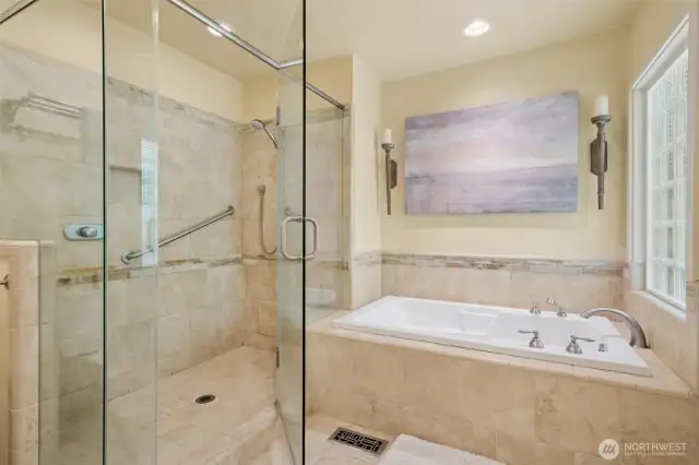 Private bath with custom tiles, soaking tub, huge walk-in shower and granite countertops.