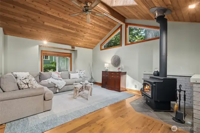 Cozy and Inviting Living Room – Gather around the gas fireplace or the rustic wood-burning stove for year-round comfort.