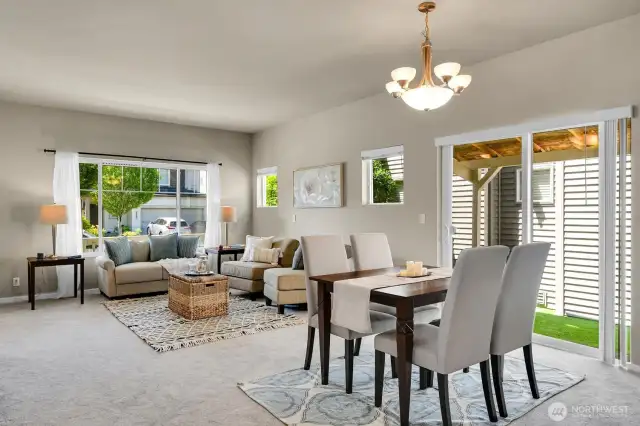A beautiful light-filled living, dining, and kitchen area
