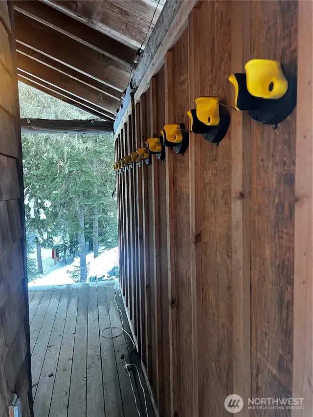 Covered front porch with 12 ski racks and room for 6 cords of wood