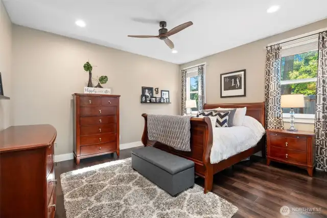This main floor retreat doesn’t skimp on space or style. Big enough for a king bed and your favorite oversized dresser, it’s a room that works for real life. A modern 3-blade ceiling fan adds a sharp design detail, while two well-placed windows bring in soft natural light throughout the day.