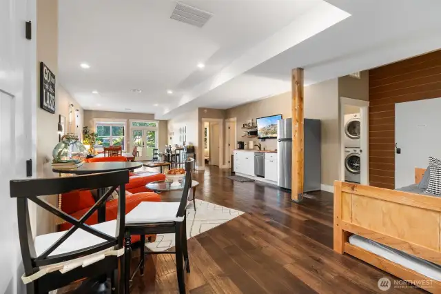 This lower-level Airbnb unit impresses with its open great room design, featuring bar-height seating, a comfy daybed with a trundle, and all the essentials including a kitchenette and stacked laundry. A remote work nook looks out through French doors to the peaceful lakeside patio, making it perfect for guests or short-term renters. You also have the option to use this as a continued space for the main home as well!