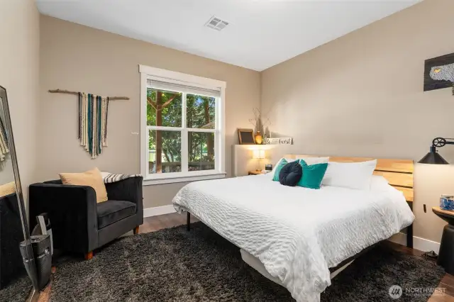 Wake up to stunning lake views in this Airbnb bedroom featuring wood-tone vinyl plank floors and all furniture included. It’s your choice to keep it separate or open the door to connect this cozy retreat directly to the main unit above.