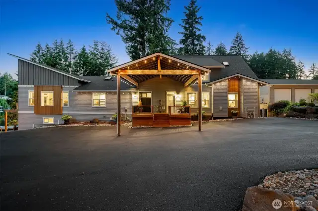 Rain or shine, the huge covered drive-thru awning has your back, making unloading groceries or guests a breeze without ever getting wet. The contemporary exterior pairs sleek lines with warm wood accents for a look that’s both modern and inviting. Plus, the expansive driveway offers easy turnaround space, so arriving and leaving feel effortless, even on busy days.