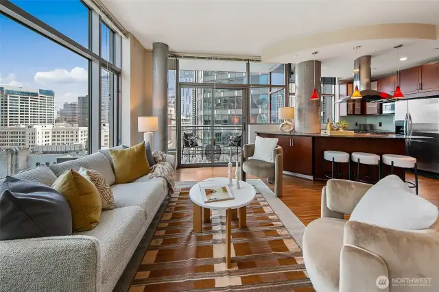 The open floorplan takes in expansive city views through the walls of windows.