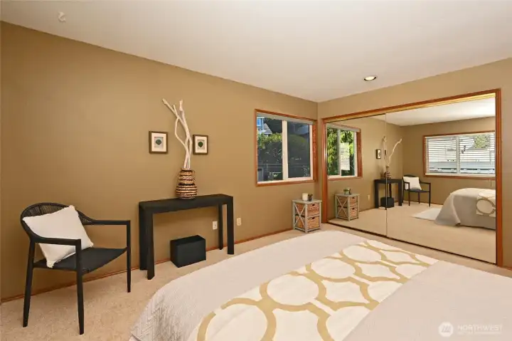 Very large closet behind mirror doors complete w/build in drawers, hanging bars and shelving.