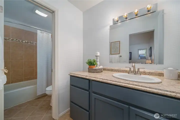 The ensuite full bath has been thoughtfully remodeled. From the freshly painted cabinetry...
