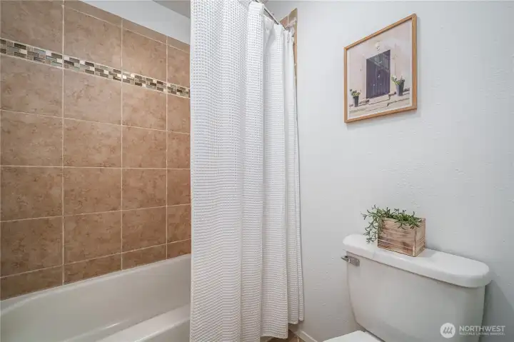 ...to the tiled floor and shower surround.