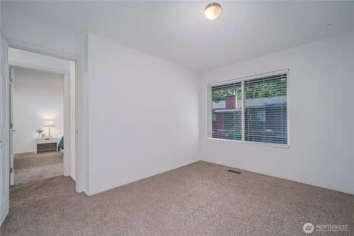 The two additional bedrooms upstairs also feature new closet doors, carpet, windows, blinds, and paint. This is one of them.