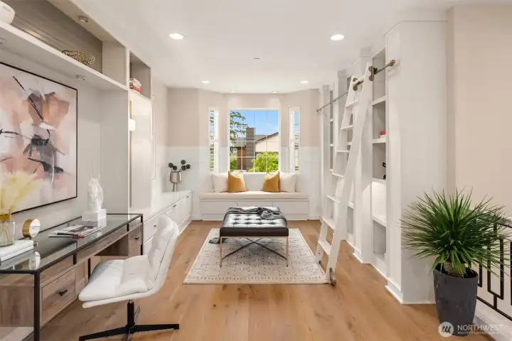 Soon upon entry, you are welcomed by the custom library with a window seat and rolling ladder, the perfect spot for quiet moments!