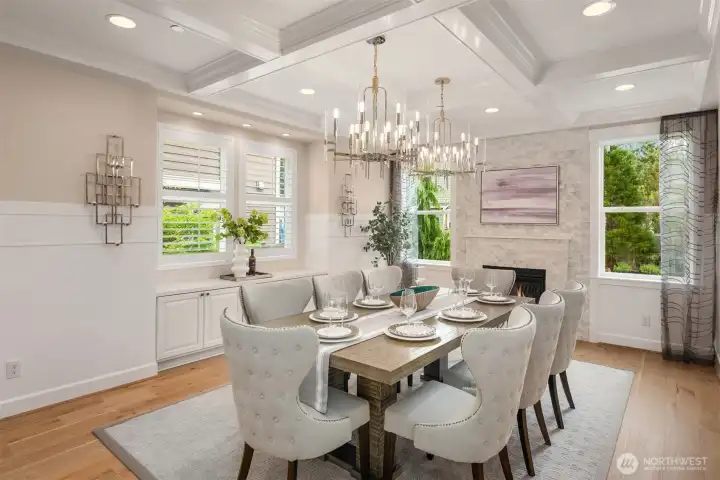 Magnificent formal dining with designer chandelier, built-in buffet, tiled gas fireplace, custom millwork, perfect for hosting your guests!