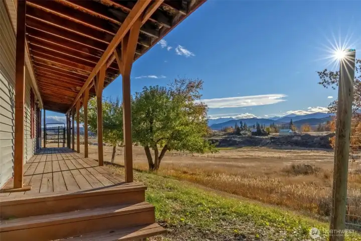 A covered porch runs the length of the home's west-facing facade