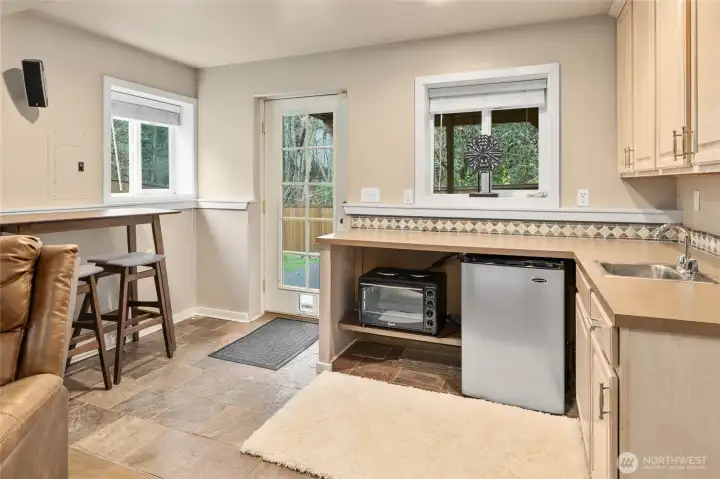 Versatile kitchenette area including space for dining table and separate entrance.