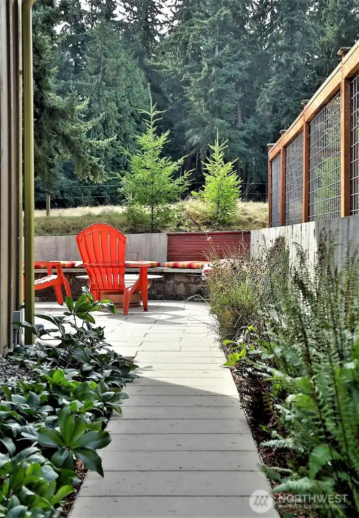 Architectural 2x4 pavers in taupe covering the back yard and walk ways with reserve planting areas.