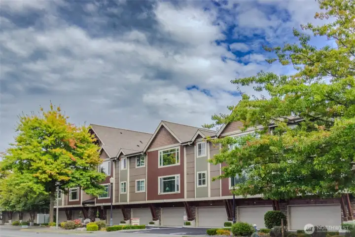 The lovely condominium complex is on a tree lined street.