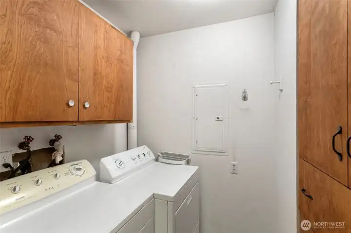 Separate laundry room with built in cupboards and drawers. Full sized Kenmore washer & dryer stay.
