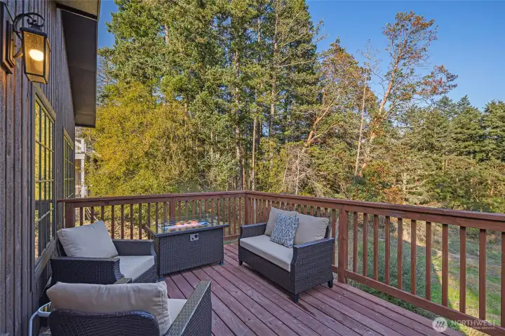 Private outdoor deck surrounded by trees offers the perfect place to relax, entertain, or enjoy morning coffee while overlooking peaceful Pacific Northwest forest views.