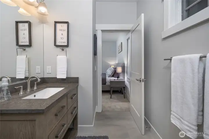 Thoughtfully designed bathroom featuring a wide vanity, contemporary fixtures, and clean modern finishes.