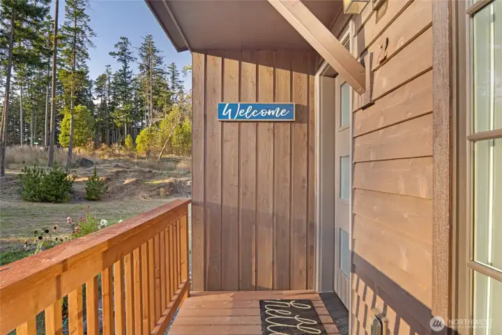 Welcoming entry deck with charming covered entry and wood siding, setting the tone for this stylish and well-maintained Friday Harbor condo residence.