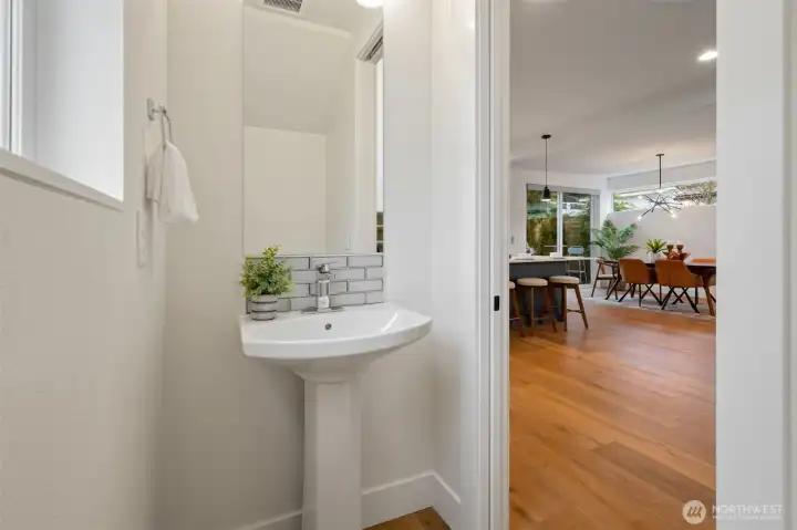 Powder room with pocket door on the main floor.