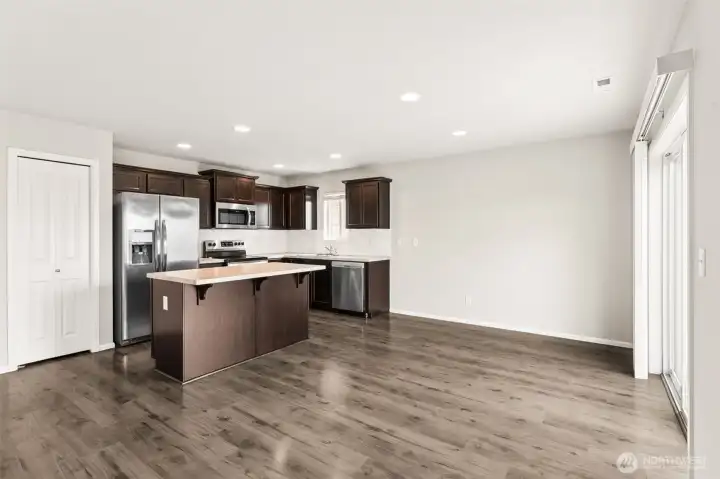 Kitchen pantry closet to the left.  White subway tile backsplash.