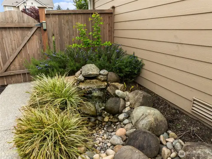 Additional space on left side of home by HOA maintained easement/gravel path.  Home is meticulously landscaped.