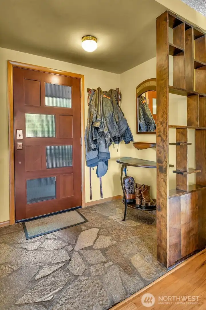 A spacious flagstone entry with gorgeous built-ins.