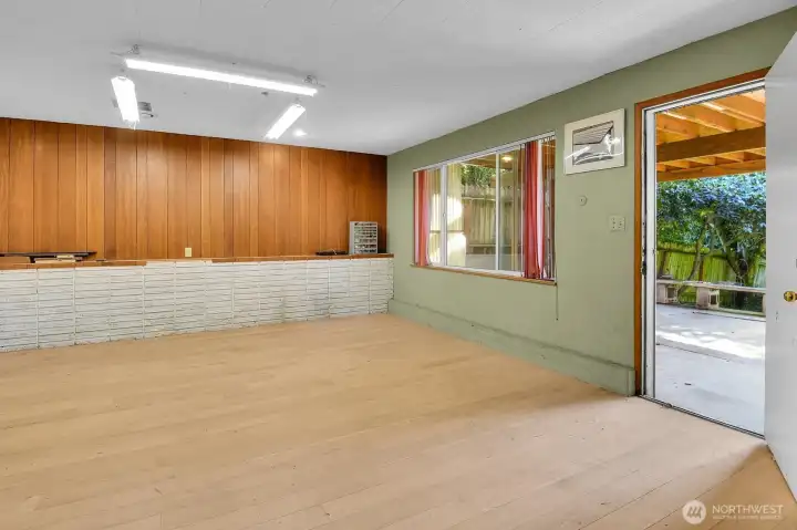 A door leads to a concrete patio under the deck (jacuzzi perhaps?).