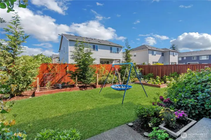 backyard with garden beds and beautiful plants/flowers. Multiple Cypress trees too. backyard with garden beds and beautiful plants/flowers. Multiple Cypress trees too.