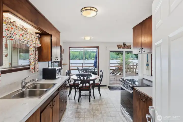 Kitchen with lake views, appliances stay.