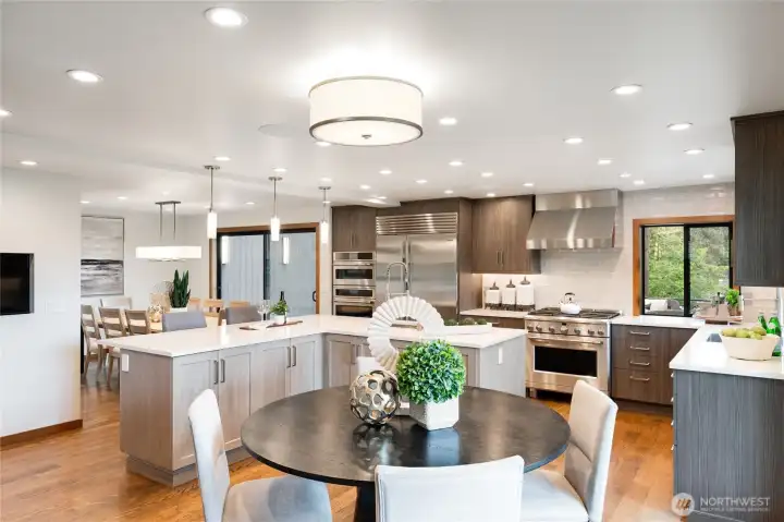 This stunning kitchen and great room is one of the many show-stopping spaces at the home. High end appliances, excellent work flow, and gorgeous light fixtures will please even the most discerning of buyers. This stunning kitchen and great room is one of the many show-stopping spaces at the home. High end appliances, excellent work flow, and gorgeous light fixtures will please even the most discerning of buyers.