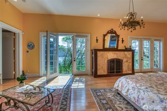 Primary Bedroom with centerpiece fireplace and French doors to water/mountain views and possible future deck
