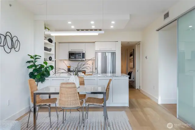 Beautiful dining under custom chandelier; floating on beautiful wide-plank European white oak flooring.