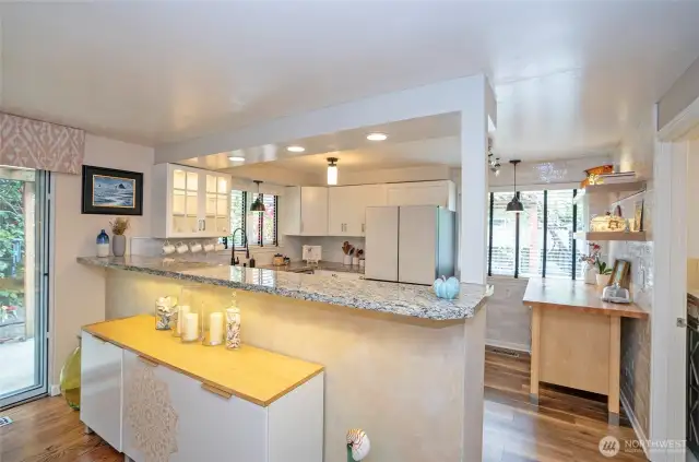 Enjoy a clear view into the spacious kitchen, where the eating bar with its solid surface countertop adds both style and function.