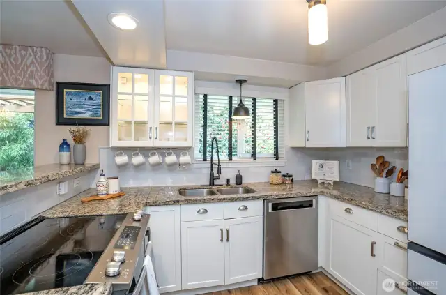 Solid countertops and accent cabinetry enhance this inviting space, making it perfect for meal preparation and everyday living.