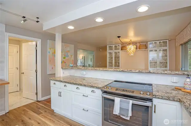 Another angle from the beautiful kitchen showcases the open and welcoming layout. The doorway to the left provides access to the utility room and a convenient 3/4 bath.