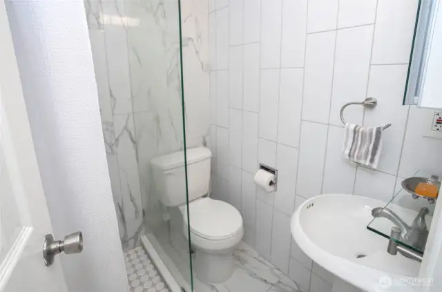 Convenient 3/4 bath located just off the utility room—perfect for guests or everyday use.