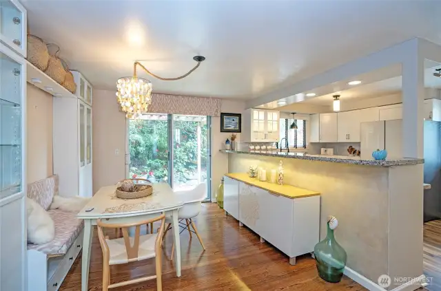 The spacious dining area, adjacent to the kitchen, features an eating bar and a sliding door that opens to a patio with arbor-covered pathways leading to the backyard. In the opposite direction, another patio awaits—graced with arbors draped in grapevines, perfect for relaxing or entertaining.