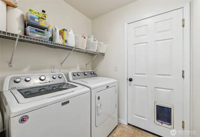 Laundry room leads to the huge garage that has room to have a car lift and space for hobbies. Washer and dryer stay!