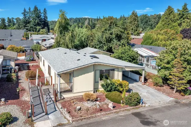 Street view of the home. Wheelchair or walker accessible. One step entry at the access door in the carport.