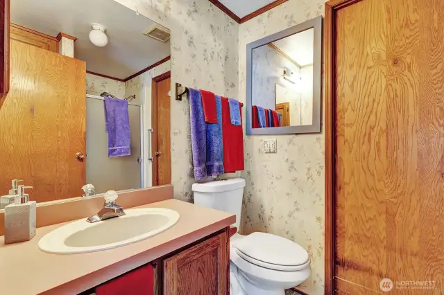 Hallway 3/4 Guest bath has step in shower. Access door also from the utility room area.