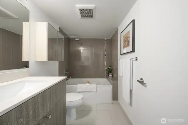 Clean and modern full bathroom off the primary bedroom.