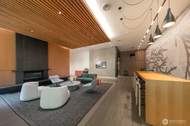 Grab a seat by the fireplace or spread out at the long work table, perfect for relaxing or remote work.